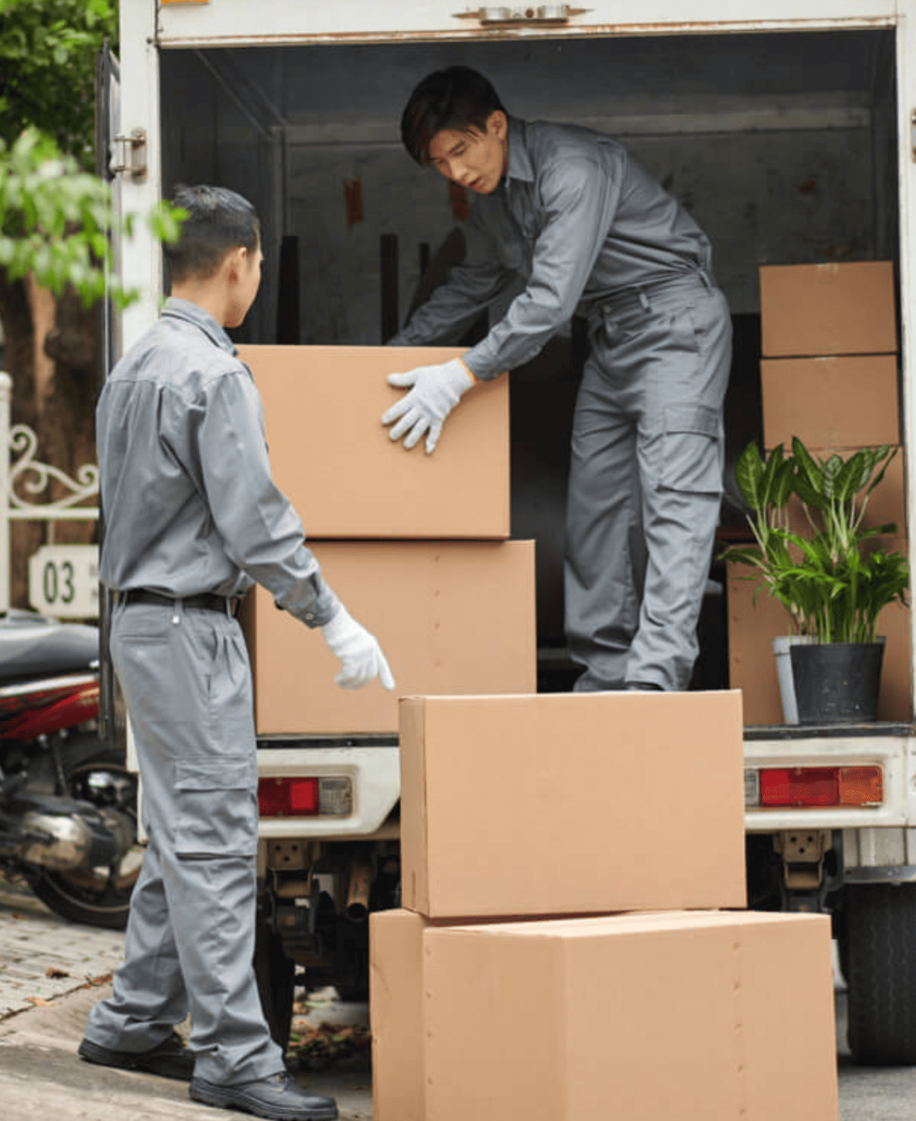 Movers loading furniture carefully into a truck’s cargo area